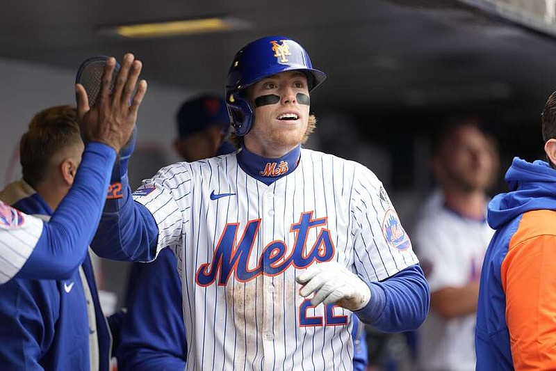 New York Mets' Brett Baty (22) celebrates in the dugout after scoring off an RBI double by DJ Stewart during the first inning of a baseball game against the Kansas City Royals, Saturday, April 13, 2024, in New York. (AP Photo/Mary Altaffer)