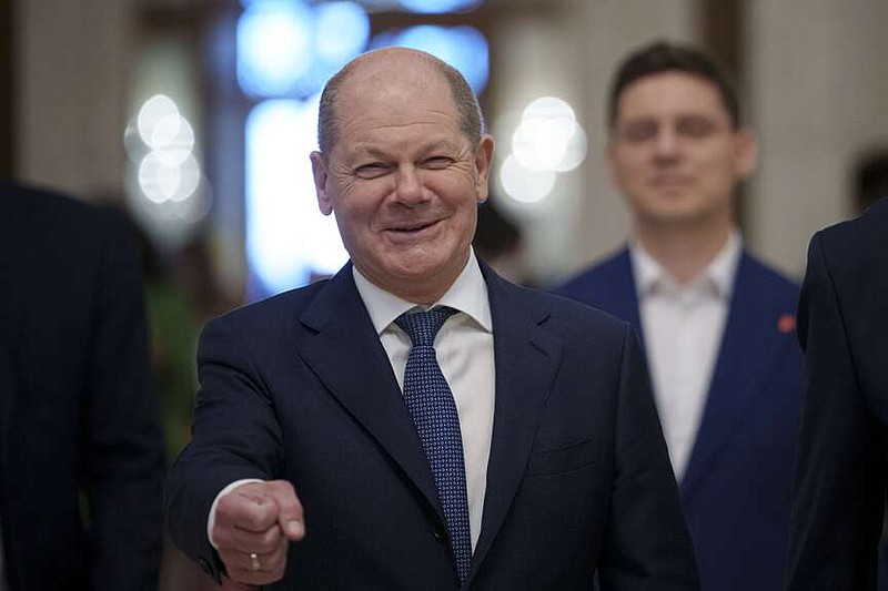 FILE - German Chancellor Olaf Scholz gestures as he arrives at the Party of European Socialists (PES) Leaders Conference, at the Palace of the Parliament, the second largest administrative building in the world after the Pentagon, in Bucharest, Romania, on April 6, 2024. Scholz arrived in China on Sunday, April 14, 2024 on a visit focused on the increasingly tense economic relationship between the sides and differences over Russia's invasion of Ukraine. (AP Photo/Andreea Alexandru, File)