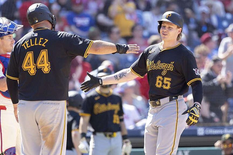 Pittsburgh Pirates' Jack Suwinski (65) is met at home by Rowdy Tellez (44) after hitting a grand slam home run during the sixth inning of a baseball game against the Philadelphia Phillies, Sunday, April 14, 2024, in Philadelphia. (AP Photo/Laurence Kesterson)