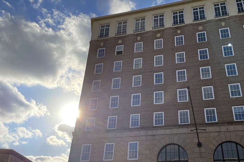 The sun sets behind the Hotel Grim on Wednesday, Nov. 8, 2023, in Texarkana, Texas. The property manager for the Lofts at the Grim, as the building will be renamed, said Monday, April 15, 2024, that new residents' move-in date has been pushed past June. Work converting the derelict hotel into an apartment building began in November 2019, and the initial estimate for a completion date was spring 2021. Ninety-three units will be available. (Staff file photo by Karl Richter)