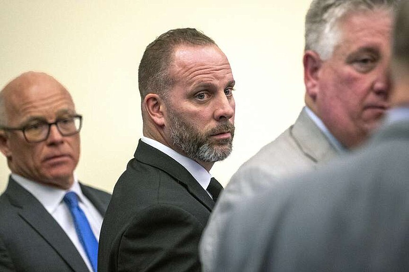 FILE - Former Franklin County Sheriff's office deputy Jason Meade, center, stands with two of his defense attorneys Steve Nolder, left, and Mark Collins, Jan. 31, 2024 in Columbus, Ohio. The retrial of the former Ohio sheriff's deputy charged with murder in the killing of a Black man will be held this fall. The Oct. 31 trial date for Meade was confirmed during a status conference held Monday, April 15, 2024 by Franklin County Common Pleas Court Judge David Young. (Brooke LaValley/The Columbus Dispatch via AP, File)