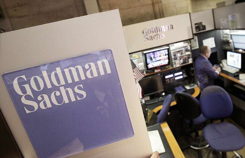 FILE - A trader works in the Goldman Sachs booth on the floor of the New York Stock Exchange, March 15, 2012. Goldman Sachs will report first quarter earnings later Thursday April 17, 2014. Goldman Sachs said Monday it saw a double-digit rise in its first-quarter profits, lifted broadly by the stock and bond markets' performances in the first months of the year. The New York-based investment bank posted net income of $4.13 billion, up 28% from a year earlier. The company earned $11.67 a share for the quarter, well above analysts expectations. (AP Photo/Richard Drew, File)