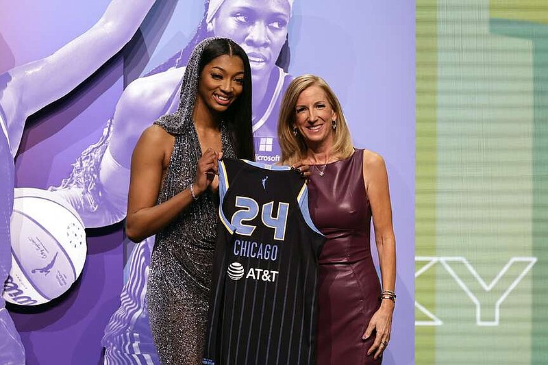 LSU's Angel Reese, left, poses for a photo
 with WNBA commissioner Cathy Engelbert after being selected seventh overall by the Chicago Sky during the first round of the WNBA basketball draft on Monday, April 15, 2024, in New York. (AP Photo/Adam Hunger)