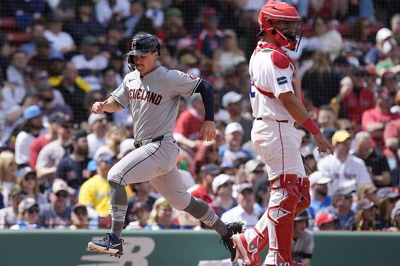 Cleveland Guardians' Will Brennan scores on an RBI double by Gabriel Arias behind Boston Red Sox catcher Reese McGuire during the ninth inning of a baseball game, Monday, April 15, 2024, in Boston. (AP Photo/Michael Dwyer)