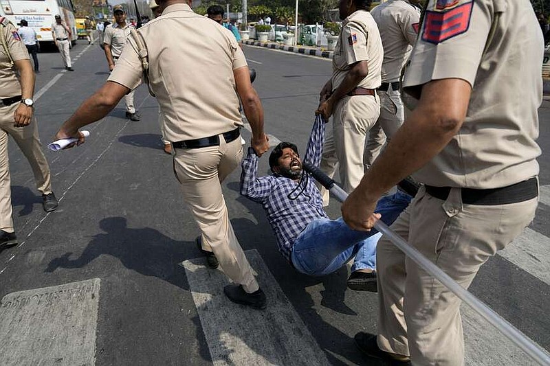 Police detain a man protesting the arrest of a leader of the Aam Aadmi Party in New Delhi, India, March 22, 2024. India's ruling Bharatiya Janata Party has brought corruption charges against many officials from opposition parties, but few convictions. (AP Photo/Manish Swarup)
