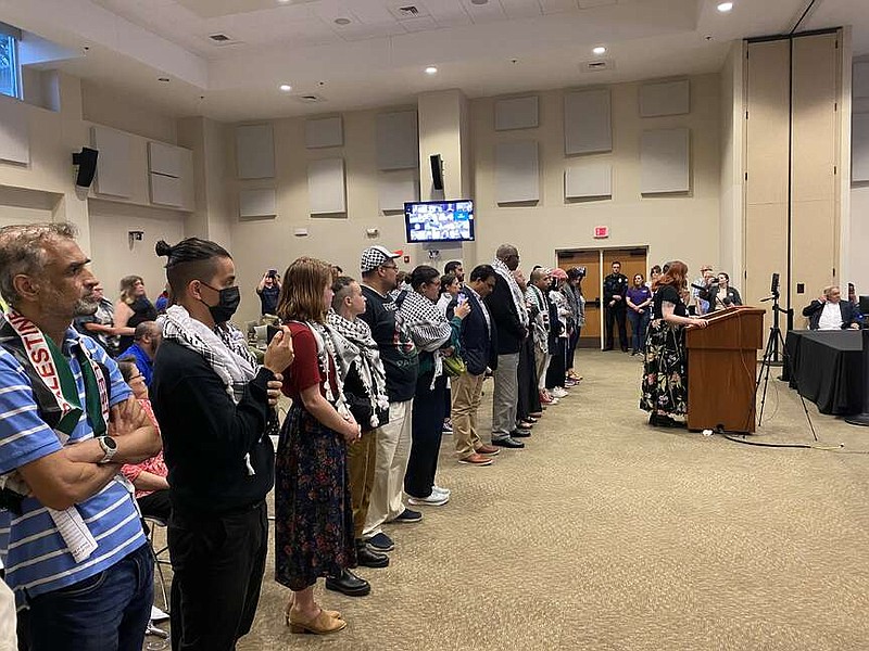 Pro-Palestinian demonstrators stand at a meeting of the Little Rock Board of Directors on Tuesday, April 16, 2024 to show their support for a ceasefire in Gaza. (Arkansas Democrat-Gazette/Joseph Flaherty)