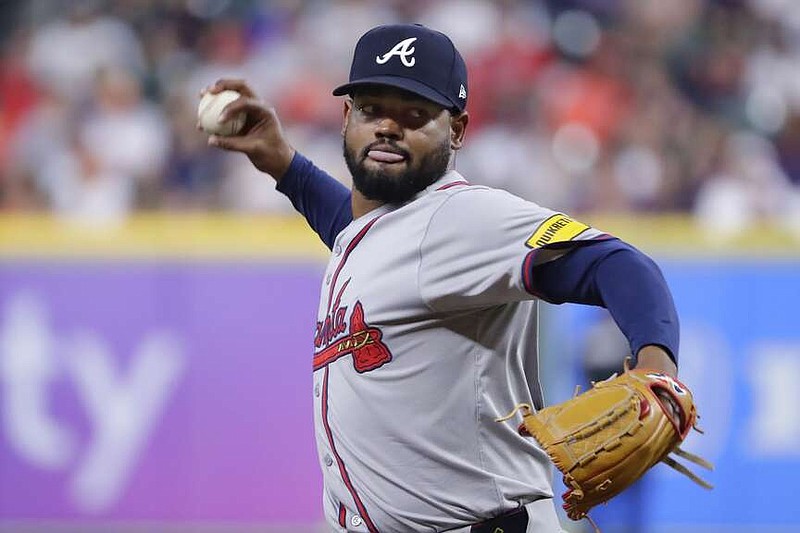 Atlanta Braves starting pitcher Reynaldo Lopez throws to a Houston Astros batter during the first inning of a baseball game Tuesday, April 16, 2024, in Houston. (AP Photo/Michael Wyke)