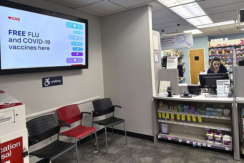 FILE - A sign for flu vaccination is displayed on a screen at a pharmacy store in Buffalo Grove, Ill., Tuesday, Feb. 13, 2024. (AP Photo/Nam Y. Huh, File)