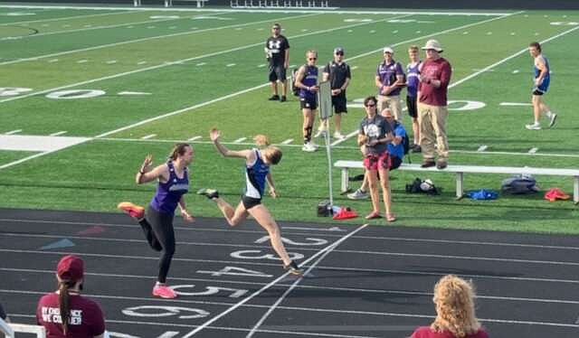 South Callaway's Reece Pahl crosses the finish line ahead of Hallsville's Marissa Austene to win the 100-meter dash at a personal record of 12.03 seconds in the Osage Varsity Invitational Tuesday at Osage High School in Osage Beach. Austene placed second at 12.45. (James Buffington/Courtesy)