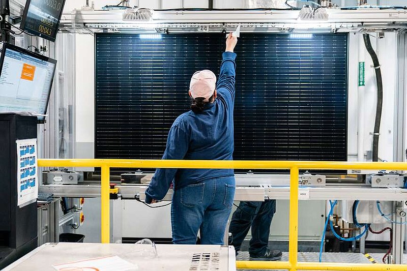 A quality control worker checks a solar panel at a solar cell and module manufacturing facility in Dalton, Ga. MUST CREDIT: Elijah Nouvelage/Bloomberg