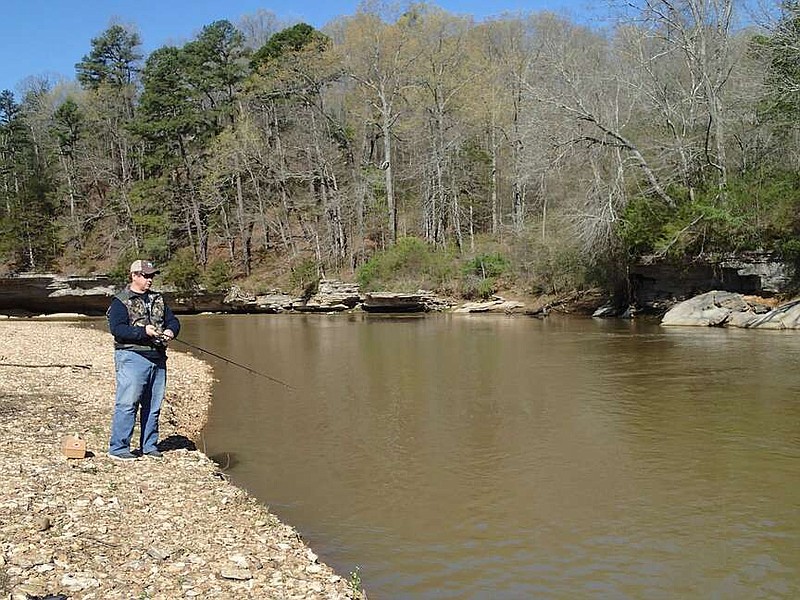 The Cemetery Hole, also called the Two Dollar Hole, on the War Eagle River is a favorite white bass destination. A generous landowner charges $2 per vehicle to cross his property to reach the river. Alan Bland of Rogers tries for white bass on April 12, but white bass didn't bite in the high, muddy water. Visit nwaonline.com/photo for today's photo gallery.
(NWA Democrat-Gazette/Flip Putthoff)
