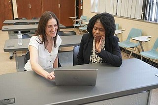 Meredith Adkins (left) University of Arkansas, Fayetteville, assistant research professor, works with Interim Chair Marilyn Bailey of the University of Arkansas at Pine Bluff on a program grant. (Special to The Commercial/University of Arkansas at Pine Bluff)