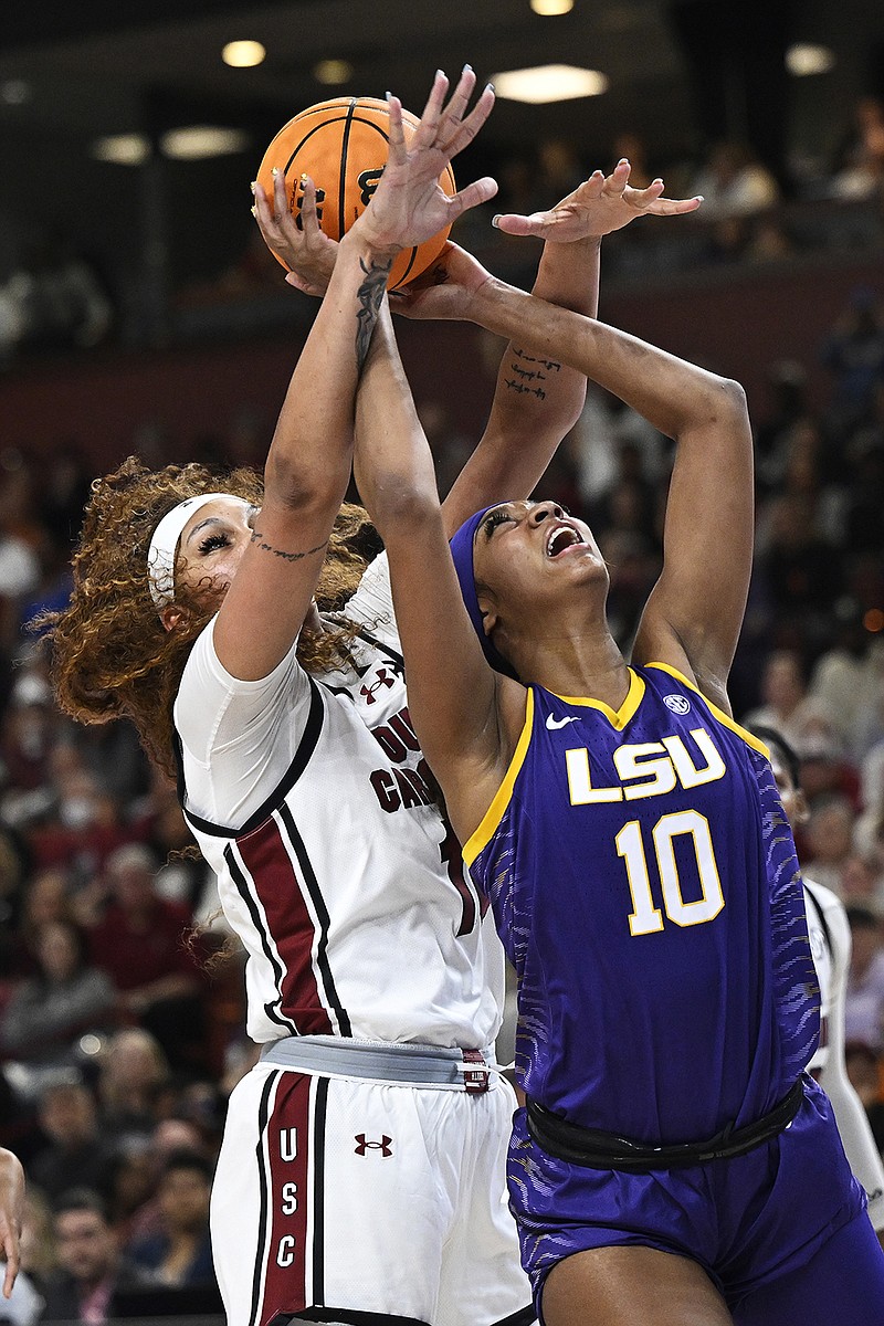 Kamilla Cardoso #10 of the South Carolina Gamecocks blocks a shot by Angel Reese #10 of the LSU Lady Tigers in the first quarter during the championship game of the SEC Women's Basketball Tournament at Bon Secours Wellness Arena on March 10, 2024, in Greenville, South Carolina. (Eakin Howard/Getty Images/TNS)