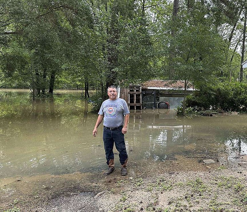Miguel Flores Sr. stands in his flooded backyard outside his home in the northeast Houston neighborhood of Kingwood on Saturday, May 4, 2024. Officials said the area had about four months of rain in about a week's time. (AP Photo/Juan Lozano)