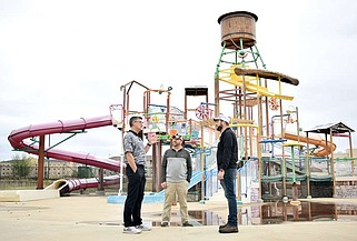 Johnny Blevins, president of P2:3 Consulting, left, speaks with Big Dam Waterpark assistant manager Matt Carson, center, and P2:3 corporate maintenance director Cole Murray on Friday afternoon, March 1, 2024, at the waterpark in Texarkana, Ark. (Staff file photo by Stevon Gamble)