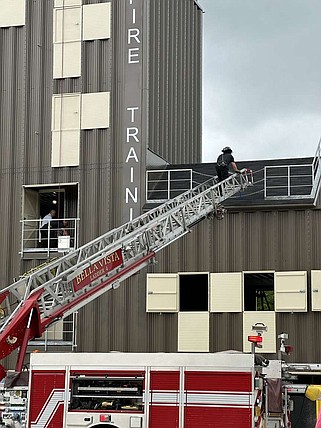 Ladder 1 extends its ladder to the second floor of the burn center May 3 to allow firefighters a way to the top of the building during an open house event at the new Fire Training Center in Bella Vista.

(NWA Democrat-Gazette/Terri O'Byrne)