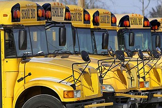 FILE - This Jan. 7, 2015 file photo shows public school buses parked in Springfield, Ill. (AP Photo/Seth Perlman, File)