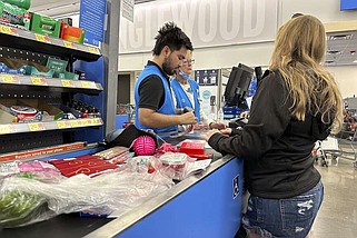 FILE - A customer checks out of a Walmart store Wednesday, Feb. 21, 2024, in Englewood, Colo. On Wednesday, May 15, 2024, the Commerce Department releases U.S. retail sales data for April. (AP Photo/David Zalubowski, File)