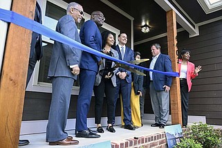 FILE - Members of the Department of Housing and Neighborhood Programs pose for a photo during a ribbon cutting outside a new affordable house in Little Rock during a ceremony recognizing the end of construction on April 3, 2024. (Arkansas Democrat-Gazette/Stephen Swofford)