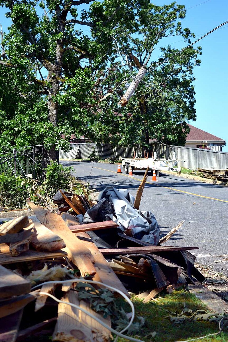 A broken utility pole hangs from its wires on Long Island Drive on May 9. (The Sentinel-Record/File/Donald Cross)