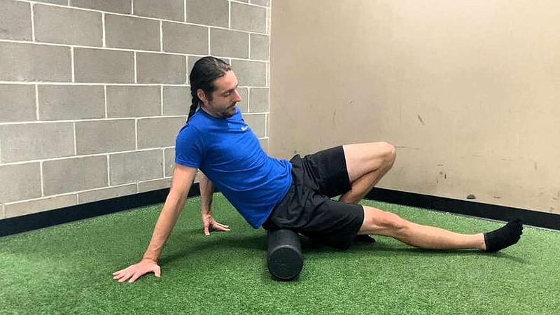 In this first of three photos, Paul Fajer demonstrates the Glute Foam Roller.
(Arkansas Democrat-Gazette/Kimberly Dishongh)