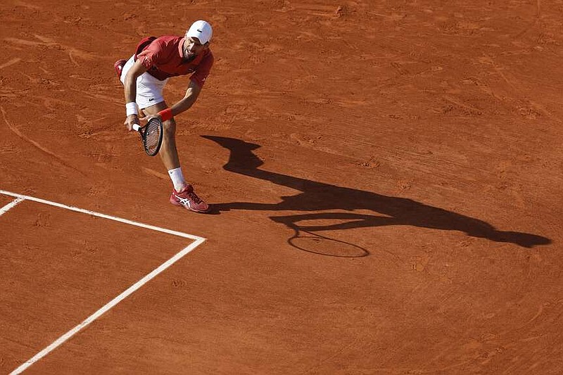 Serbia's Novak Djokovic plays a shot against Argentina's Francisco Cerundolo during their fourth round match of the French Open tennis tournament at the Roland Garros stadium in Paris, Monday, June 3, 2024. (AP Photo/Jean-Francois Badias)