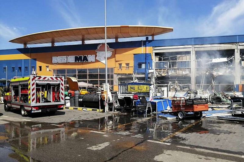 In this photo released by Romanian Emergency Services (ISU Botosani), firefighters work at the scene of an explosion at a chain DIY store in Botosani, Romania, Friday, June 7, 2024. An explosion at a chain DIY store in northwest Romania on Friday injured at least 13 people, one seriously, but caused no fatalities, authorities said.( Romanian Emergency Services - ISU Botosani via AP)