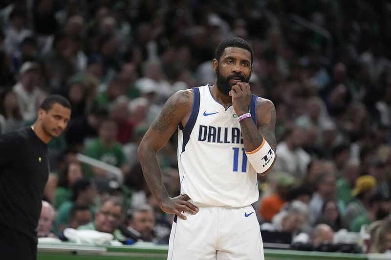 Dallas Mavericks guard Kyrie Irving pauses on the court in front of Boston Celtics head coach Joe Mazzulla, left, during the first half of Game 5 of the NBA basketball finals, Monday, June 17, 2024, in Boston. (AP Photo/Charles Krupa)