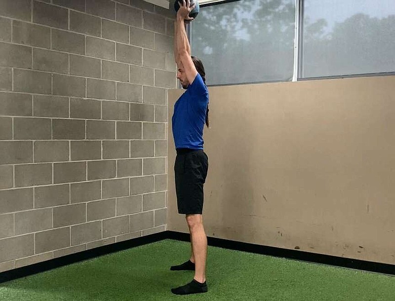 In this first of three photos, Paul Fajer demonstrates Medicine Ball Good Morning for Matt Parrott's Master Class. (Arkansas Democrat-Gazette/Kimberly Dishongh)