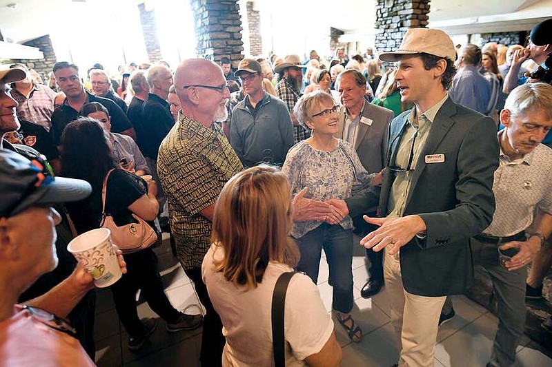 Tom Walton (right), co-founder of Runway Group, speaks May 10 to a large group of residents during a public meeting hosted by Blue Crane at the Bella Vista Country Club. Representatives from Blue Crane, the city of Bella Vista and the Bella Vista POA spoke to residents about a recent land and developer rights acquisition.
(File Photo/NWA Democrat-Gazette/Andy Shupe)