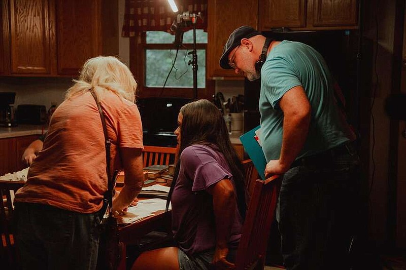 Director Jason Pitts (right) goes over the script with his cast and crew.

(Special to the Democrat-Gazette/Lucid Lake Pictures)