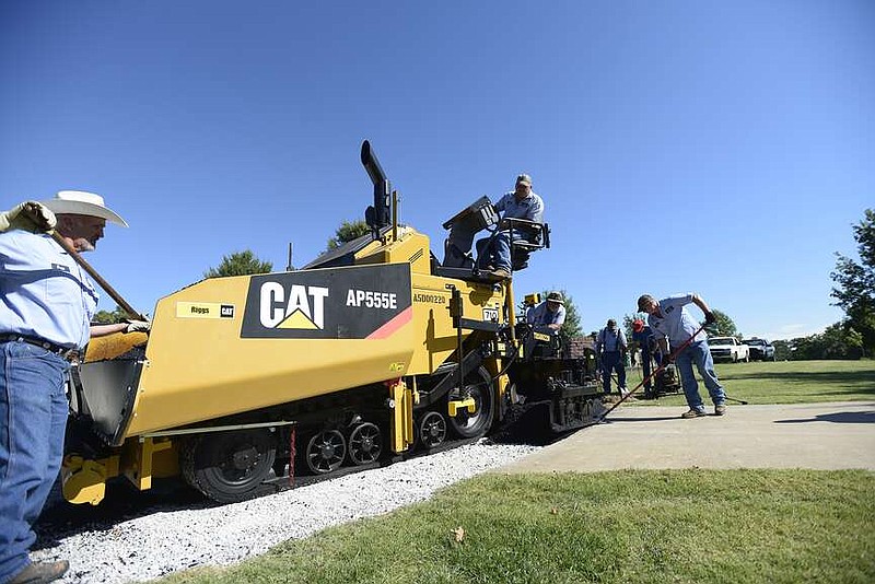 Crews with the Springdale Public Works Department pave a road Thursday, Oct. 10, 2013 on Greenbriar Road in Springdale. (NWA Democrat-Gazette/FILE PHOTO)