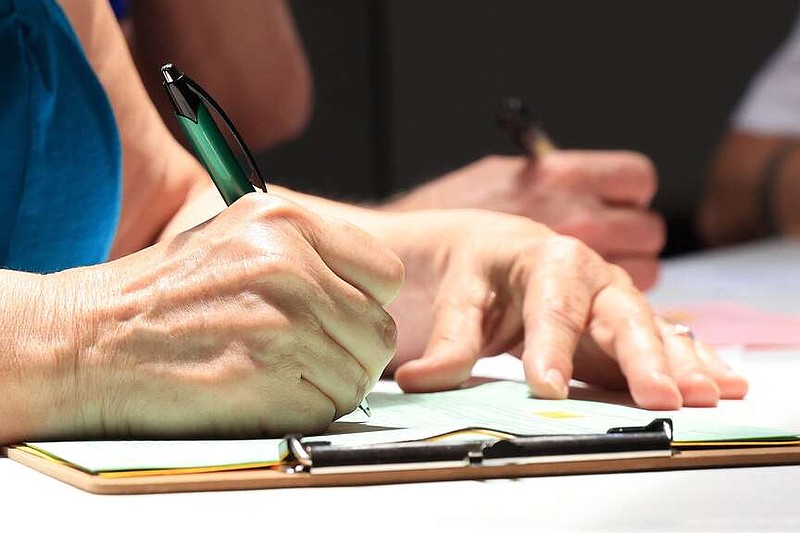 Dianne Johnson fills out several petitions at the headquarters of the Democratic Party of Arkansas in Little Rock on Friday, June 28, 2024. The deadline for the petitions, which includes one on the abortion amendment, are due July 5. (Arkansas Democrat-Gazette/Colin Murphey)