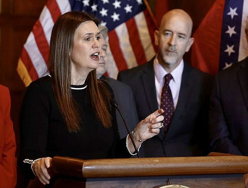 Gov. Sarah Huckabee Sanders speaks in this Feb. 14, 2024 file photo along with Education Secretary Jacob Oliva during a news conference at the state Capitol in Little Rock. (Arkansas Democrat-Gazette/Thomas Metthe).