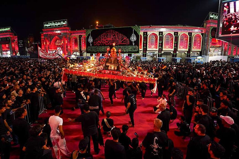 Iraqi Shiites mark the month of Muharram in Karbala, Iraq, on Tuesday, July 16, 2024. Muharram commemorates the death of Prophet Muhammed's grandson, Hussein Ibn Ali, who was killed during the Battle of Karbala on the tenth day of Muharram, known as the Day of Ashoura. ( (AP Photo/Anmar Khalil)