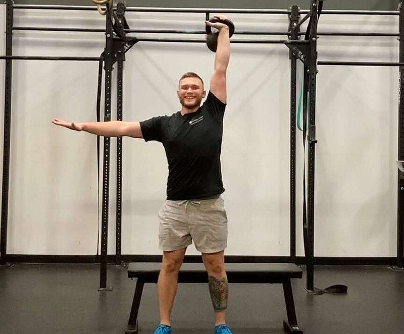 In this first of three photos, JD Stephenson, a personal trainer at the Little Rock Athletic Club, demonstrates Kettlebell Bench Squat Press for Matt Parrott's Master Class. (Arkansas Democrat-Gazette/Kimberly Dishongh)