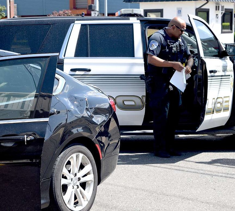 Hot Springs police respond to the scene of a wreck in April. Three new officers are scheduled to start work next week. (The Sentinel-Record/File)