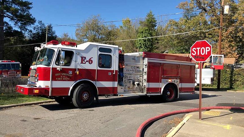 Hot Springs firefighters are shown relocating equipment at the scene of a fire in November 2022. (The Sentinel-Record/File)