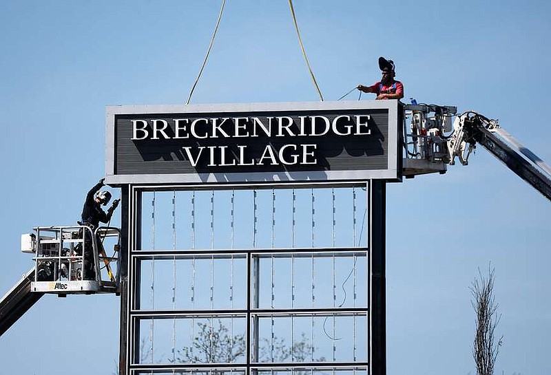 Workers with Ace Signs weld the new sign for the Breckenridge Village shopping center on Wednesday, March 20, 2024, in Little Rock. (Arkansas Democrat-Gazette/Thomas Metthe)