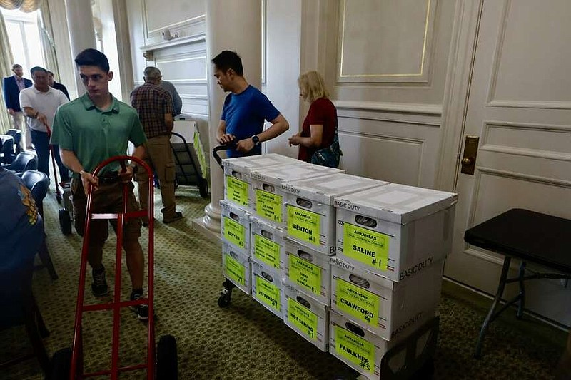 Volunteers deliver signatures for the repeal Pope County casino amendment at the state Capitol on Friday, 5 July 2024.  (Arkansas Democrat-Gazette/Thomas Metthe).