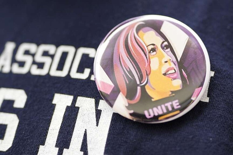 Torrick Ward wears a button with the face of Vice President Kamalas Harris at a meeting of volunteers who will be canvassing for Harris and other Democrats in Michigan and Wisconsin, Sunday, July 28, 2024, at the 49th Ward offices in Chicago. (AP Photo/Erin Hooley)