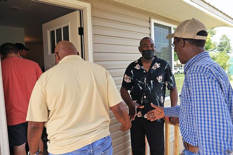 Willie Greer, second from right, greets guests and family at his new home in Wynne on Monday, July 29, 2024. Greer's new home was built with help from the Wynne Church of Christ, Arkansas Community Foundation, Wynne Relief and Recovery and the city of Wynne after his previous home was destroyed in the March 31, 2023 tornado which decimated the area. (Arkansas Democrat-Gazette/Colin Murphey)