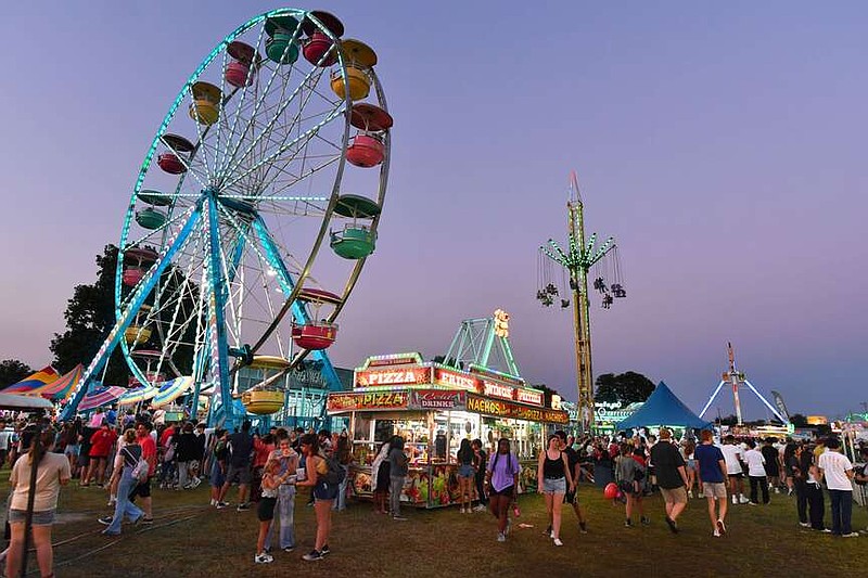 Visitors ride the Ferris wheel Thursday, Aug. 4, 2022, during the 123rd Tontitown Grape Festival in Tontitown. The festival continues through Saturday. Visit nwaonline.com/220805Daily/ for today's photo gallery. 
(NWA Democrat-Gazette/Andy Shupe)