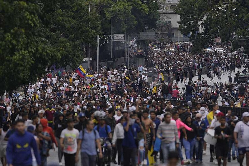 Protesters demonstrate against the official election results declaring President Nicolas Maduro the winner, the day after the presidential election in Caracas, Venezuela, Monday, July 29, 2024. (AP Photo/Matias Delacroix)