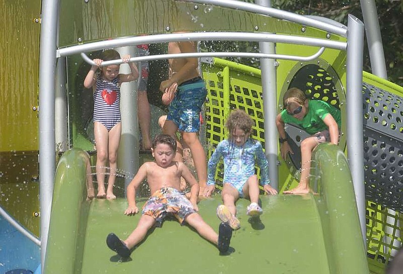 Youngsters beat the July heat on Wednesday July 19 at the splash pad inside Creekside Park, 3104 SW Bright Road in Bentonville. (NWA Democrat-Gazette/Flip Putthoff)