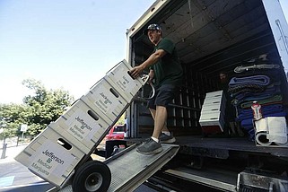 Boxes of signatures for a proposed medical marijuana amendment are wheeled into the state Capitol in Little Rock on July 5, 2024. (Arkansas Democrat-Gazette/Thomas Metthe)