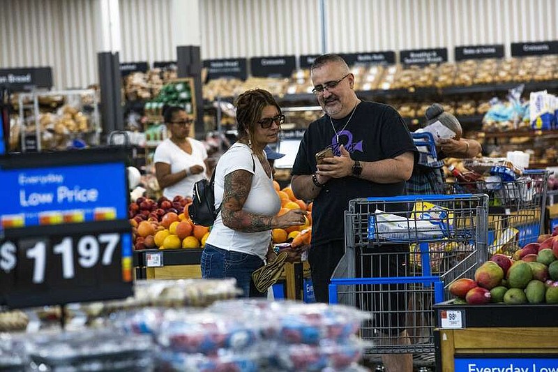 People buy groceries at a Walmart Superstore in Secaucus, New Jersey, Thursday, July 11, 2024. (AP Photo/Eduardo Munoz Alvarez)