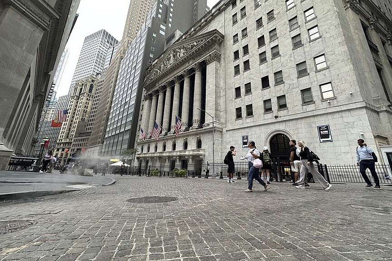 FILE - People pass the New York Stock Exchange on July 31, 2024 in New York. World shares have tumbled on Friday with Japan's Nikkei 225 index slumping 5.8% as investors panicked over signs of weakness in the U.S. economy.(AP Photo/Peter Morgan, File)