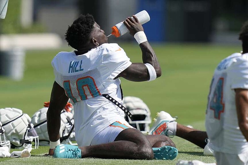 Miami Dolphins wide receiver Tyreek Hill (10) takes a drink during the NFL football team's training camp Monday, July 29, 2024, in Miami Gardens, Fla. (AP Photo/Lynne Sladky)