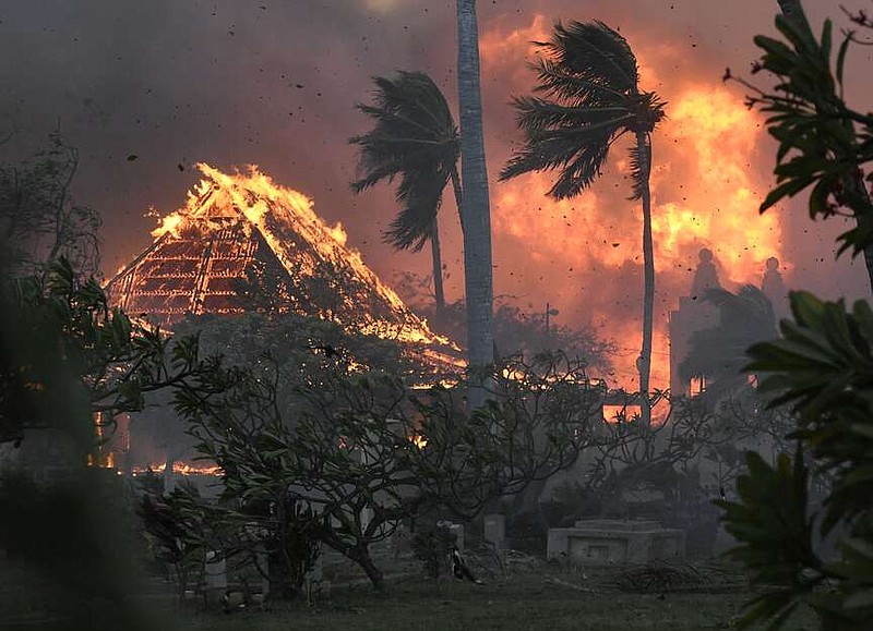 FILE - Waiola Church and nearby Lahaina Hongwanji Mission are engulfed in flames along Wainee Street, Aug. 8, 2023, in Lahaina, Hawaii. The parties in lawsuits seeking damages for last year's Maui wildfires have reached a $4 billion global settlement, a court filing said Friday, Aug. 2, 2024. The agreement comes nearly one year after the deadliest U.S. wildfire in more than a century killed 102 people and destroyed the historic downtown area of Lahaina on Maui. (Matthew Thayer/The Maui News via AP, File)